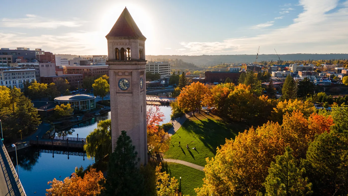 The Riverfront Park clock tower and Spokane River in downtown Spokane at sunset
